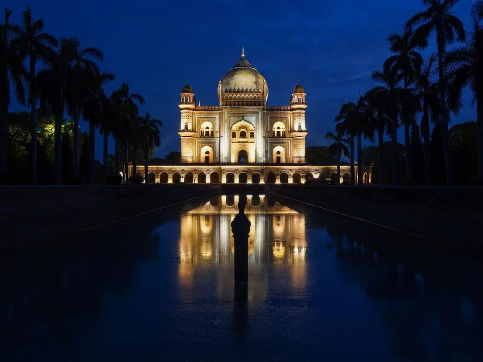 Safdarjung's Tomb lit up at night and reflected in its long water channel