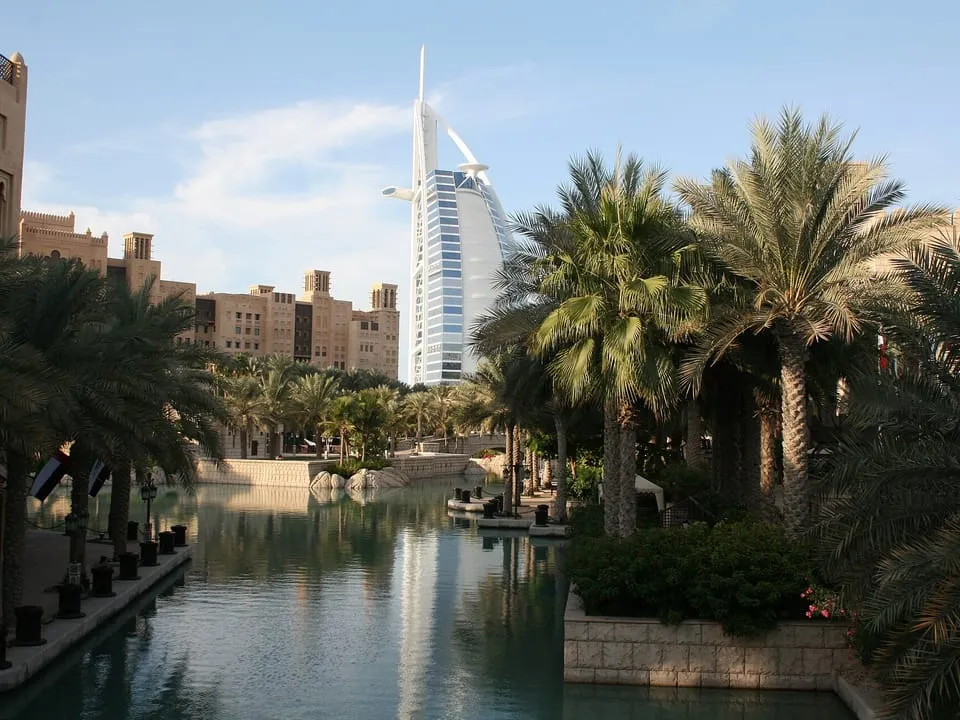 A palm-lined canal at Madinat Jumeirah, with the Burj Al Arab behind