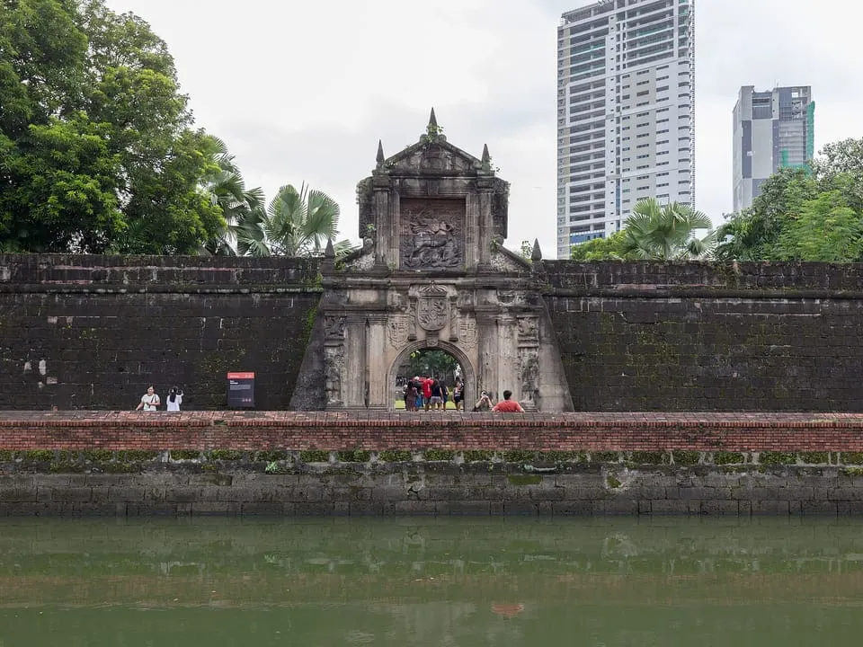 The carved stone gate of Fort Santiago in Intramuros, seen across its moat